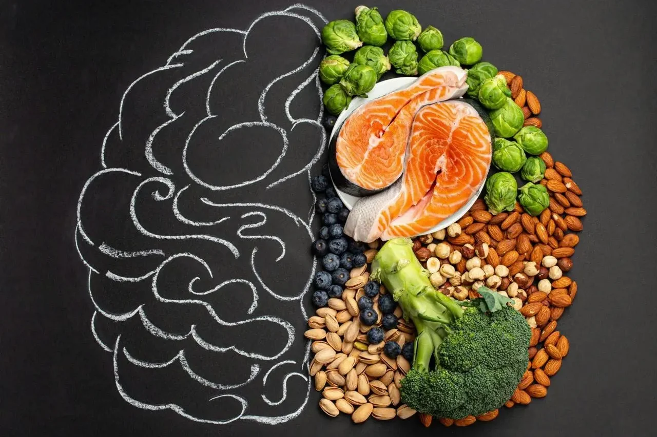 an outline of a brain with half of it filled with healthy food